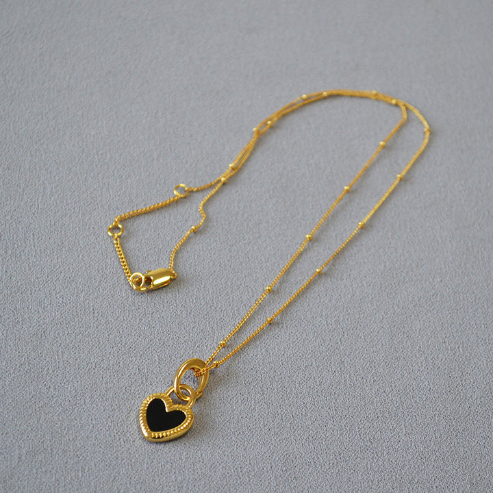 Gold Heart-Shaped Pendant Necklace with Black and White Accents