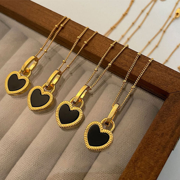 Gold Heart-Shaped Pendant Necklace with Black and White Accents
