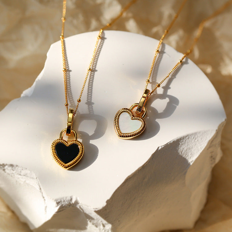 Gold Heart-Shaped Pendant Necklace with Black and White Accents