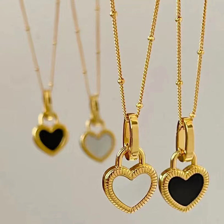 Gold Heart-Shaped Pendant Necklace with Black and White Accents