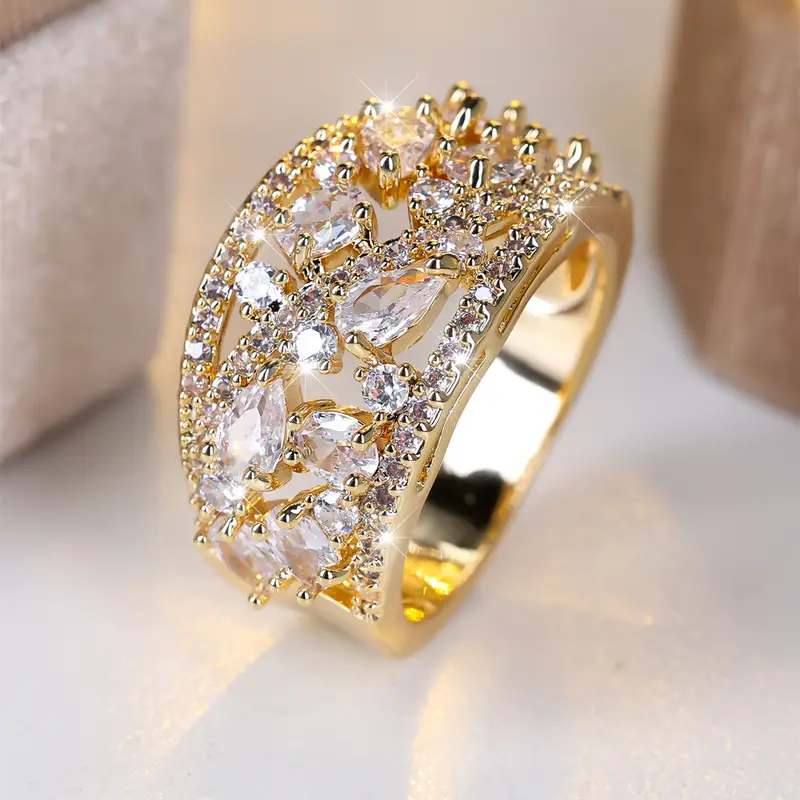 Gold Ring with White Crystals" can be rewritten as "Elegant Gold Ring with Sparkling White Crystals.